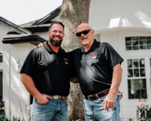 Two men in matching black shirts
